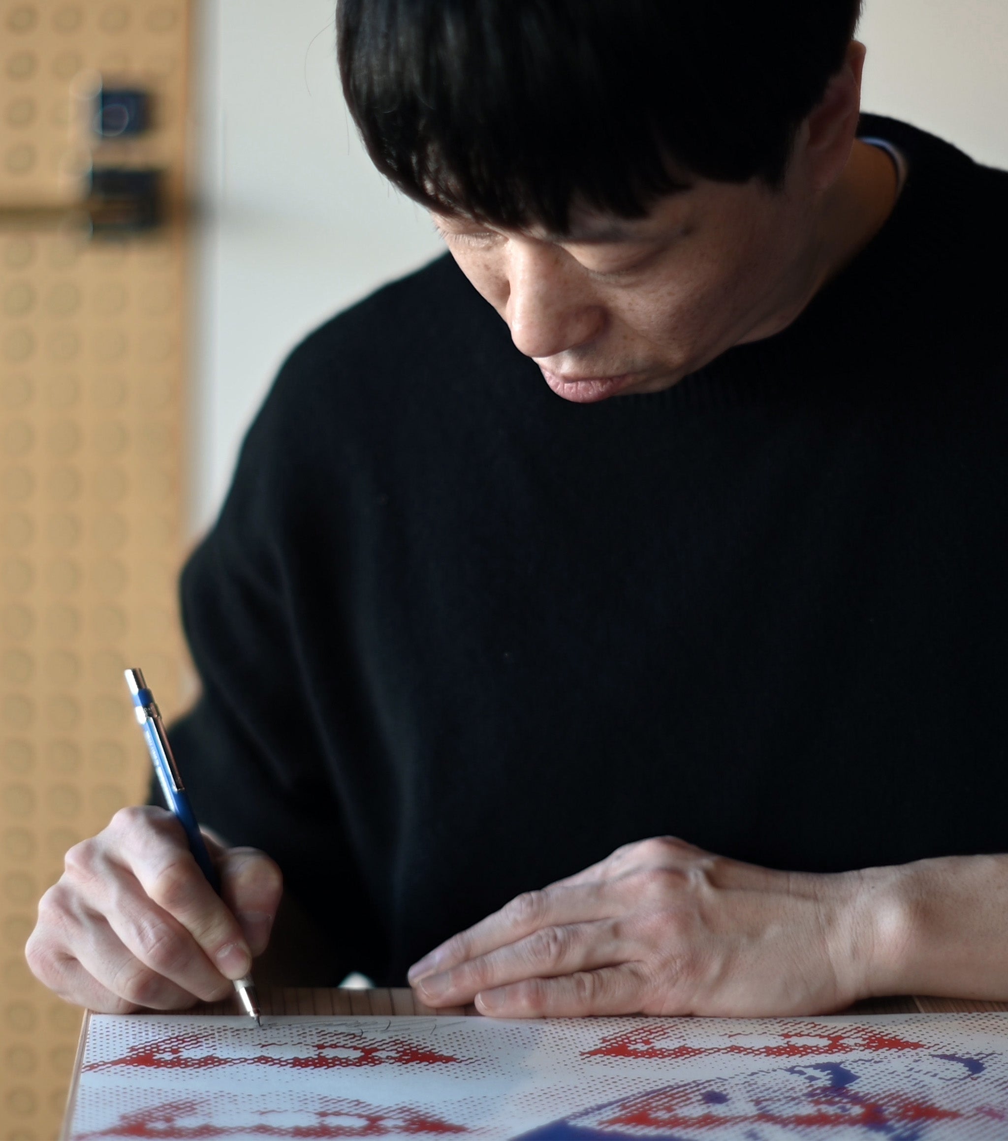 Kosuke Kawamura signing an autograph